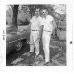 Jim Oliver and Hamper McBee posing while washing Jim's old 49 Ford, think they hauled any Moonshine in that car.