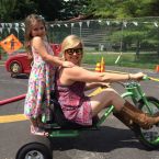 Playground with Big Wheel tricycles for adults, fenced & painted track for riding, yard games for all ages, and bicycle rentals!