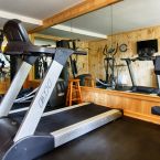 The Fitness Center has five work stations, floor to ceiling mirrored wall, and beautiful pine plank paneling..