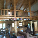 446 Log Cabin Great Room Vaulted Ceiling, all wood beams, timbers, and planking above, loft above has 3 queen beds and 2 sleeper sofas.